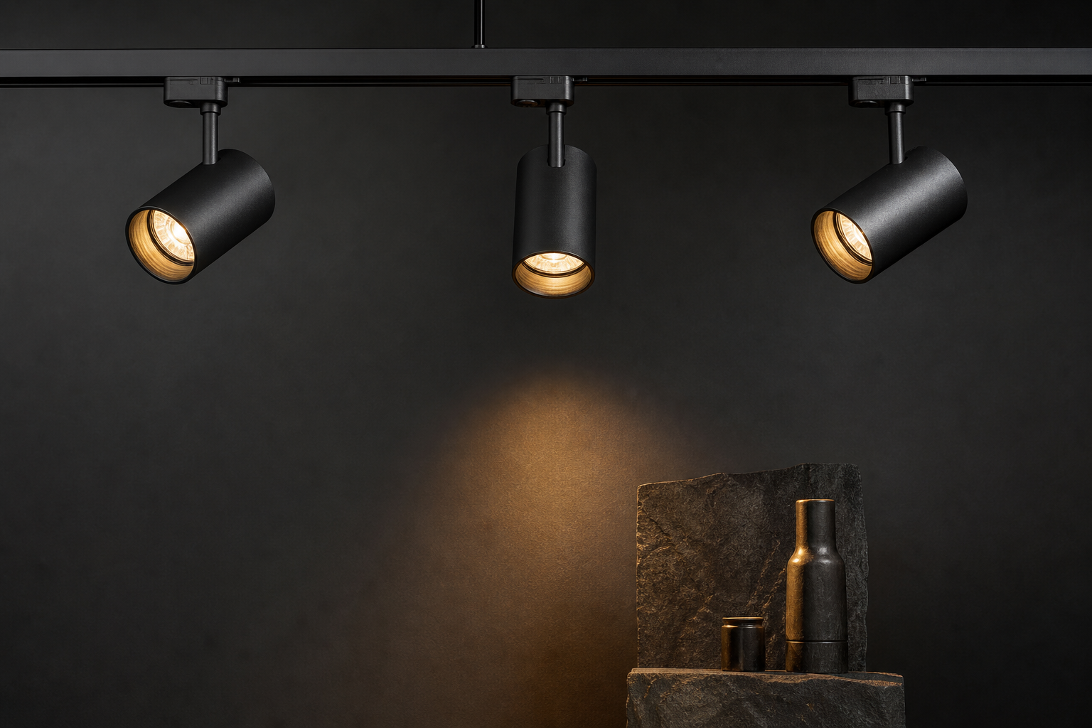 Track lighting spotlights aimed at a dark gallery wall